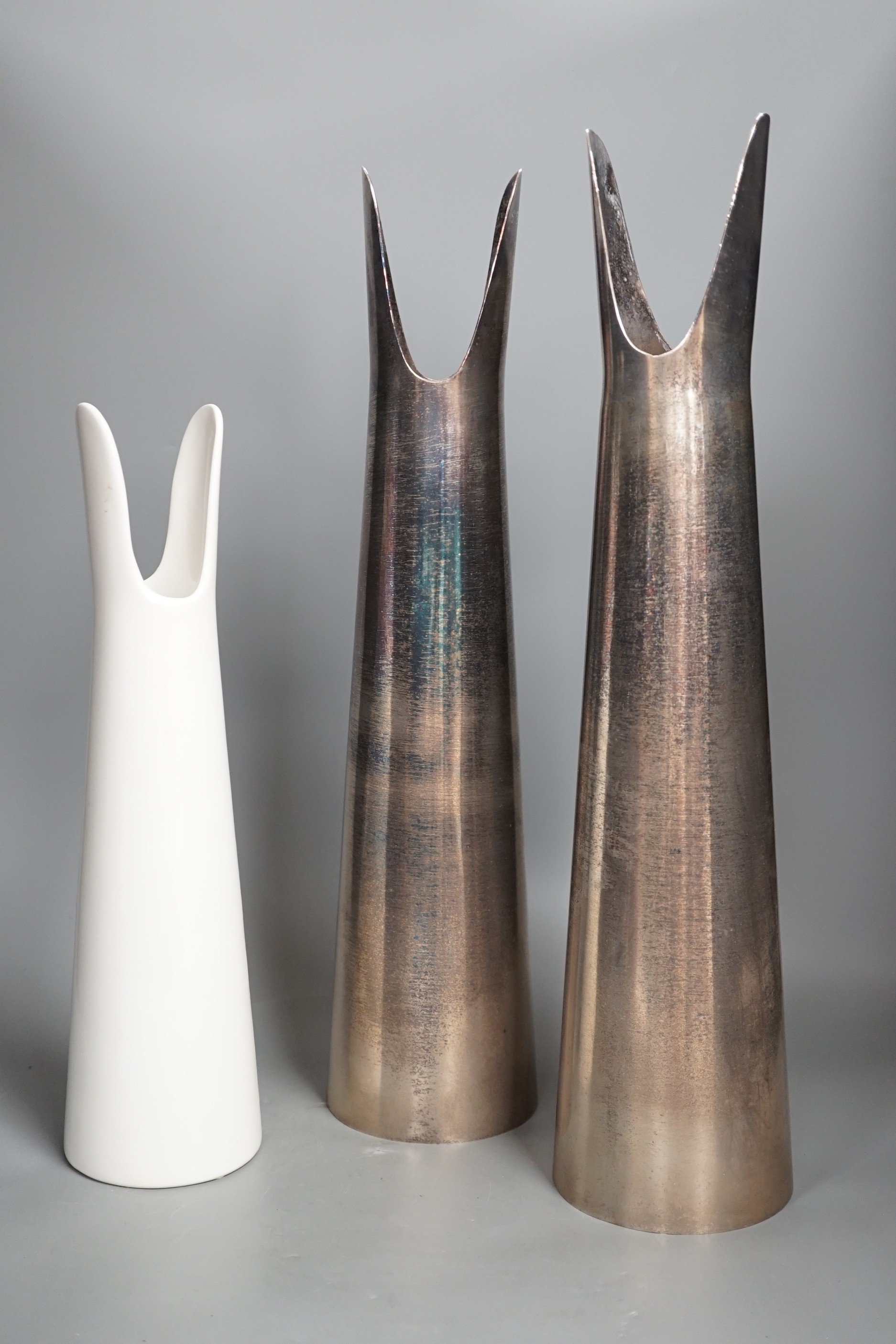 A Sophie Suchodolski ceramic vase and a pair of matching steel vases. Tallest 52cm